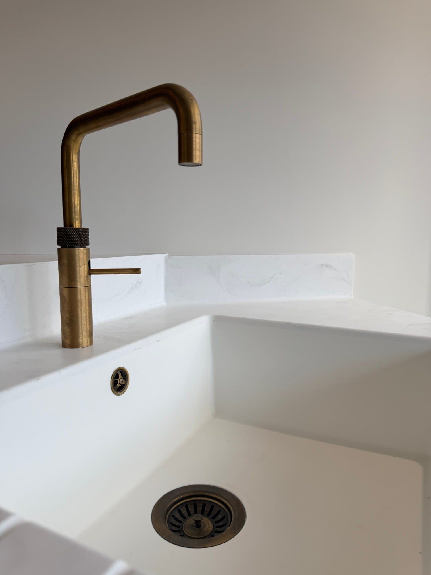 Brass tap over a kitchen sink